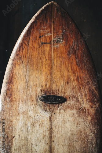 Close-up shot of a wooden surfboard in a room photo