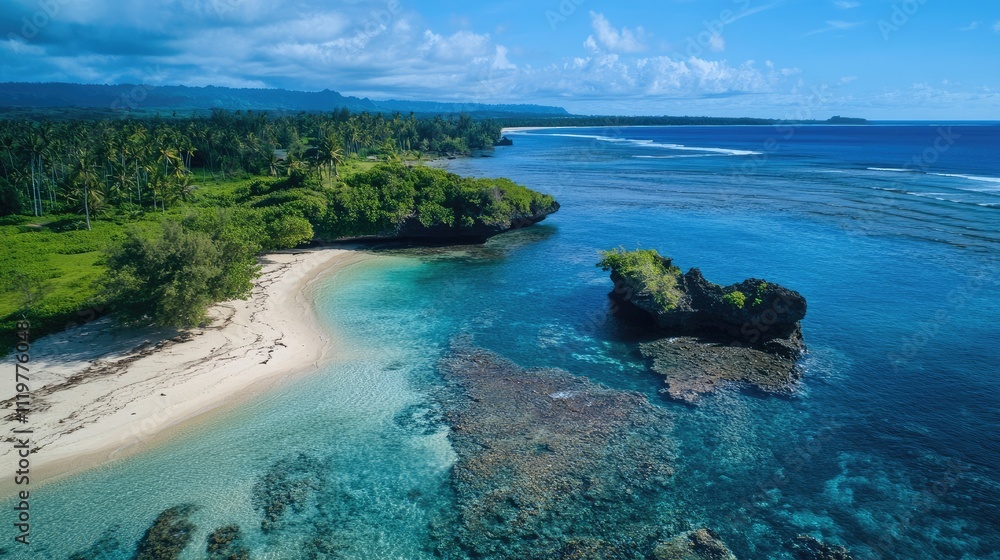 Fototapeta premium Aerial view of a pristine beach and small rocky islet surrounded by clear blue waters and lush greenery under a vibrant sky