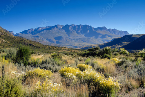 A scenic mountain landscape with a clear blue sky,