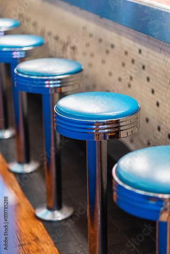 Retro Diner Bar Stools in Classic Blue Leather and Chrome Finish Evoking Vintage Ambiance and Nostalgia of 1950s American Diners with Unique Interior Design and a Timeless Hospitality Charm