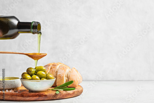 Pouring Olive Oil over Green Olives