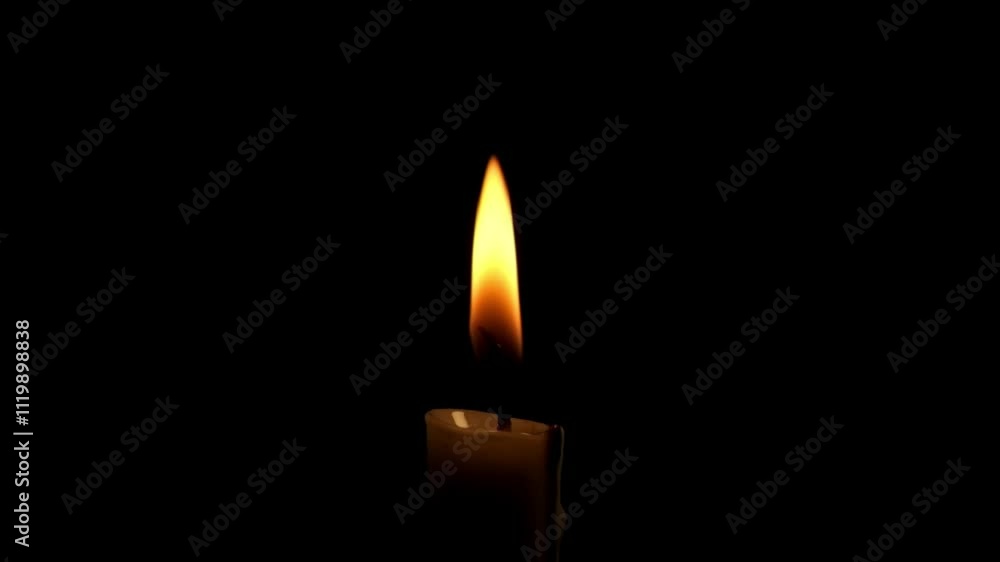 Close up of a burning candle flame isolated on a black background.The candle flame sways slowly.The concept of hope and enthusiasm.Copy space for text.Real time raw video no edit.For transition videos Close up of a burning candle flame isolated on a black background.The candle flame sways slowly.The concept of hope and enthusiasm.Copy space for text.Real time raw video no edit.For transition videos