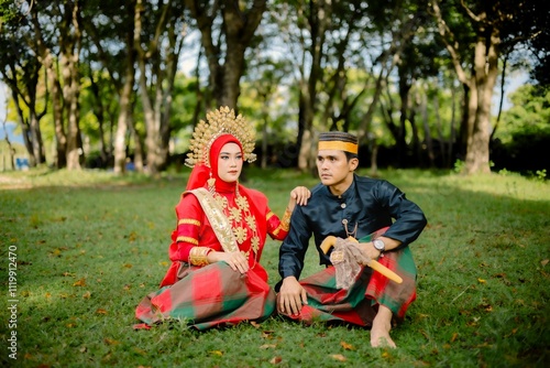 Portrait of Asian Men and Women wearing traditional Bugis clothes posing for pre-wedding