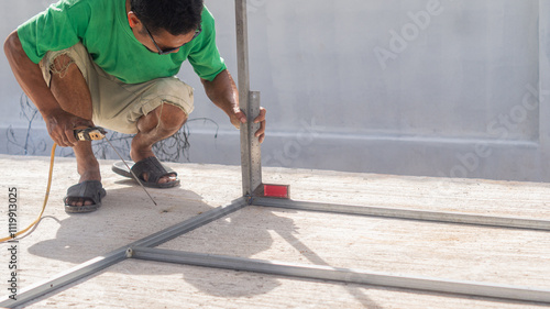 Wallpaper Mural Worker measures angle of steel with right angle ruler before welding, worker makes metal structure in construction site Torontodigital.ca