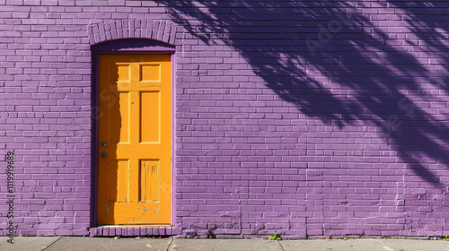 Bright Purple Brick Wall with Vibrant Orange Door on a Sunny Day. Concept of Urban Architecture, Colorful Building Design, Creative Street Art, Cityscape, Exit, Entrance. Copy space photo