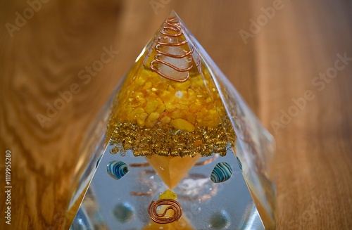 High resolution image of a single isolated beautiful one of a kind hand made Orgone pyramid generator containing crystals photo