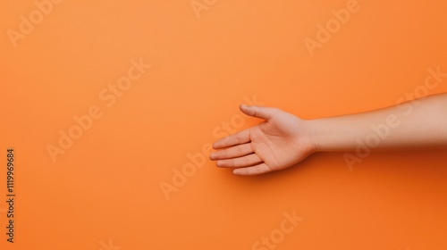Helping hand reaching out against a solid orange background