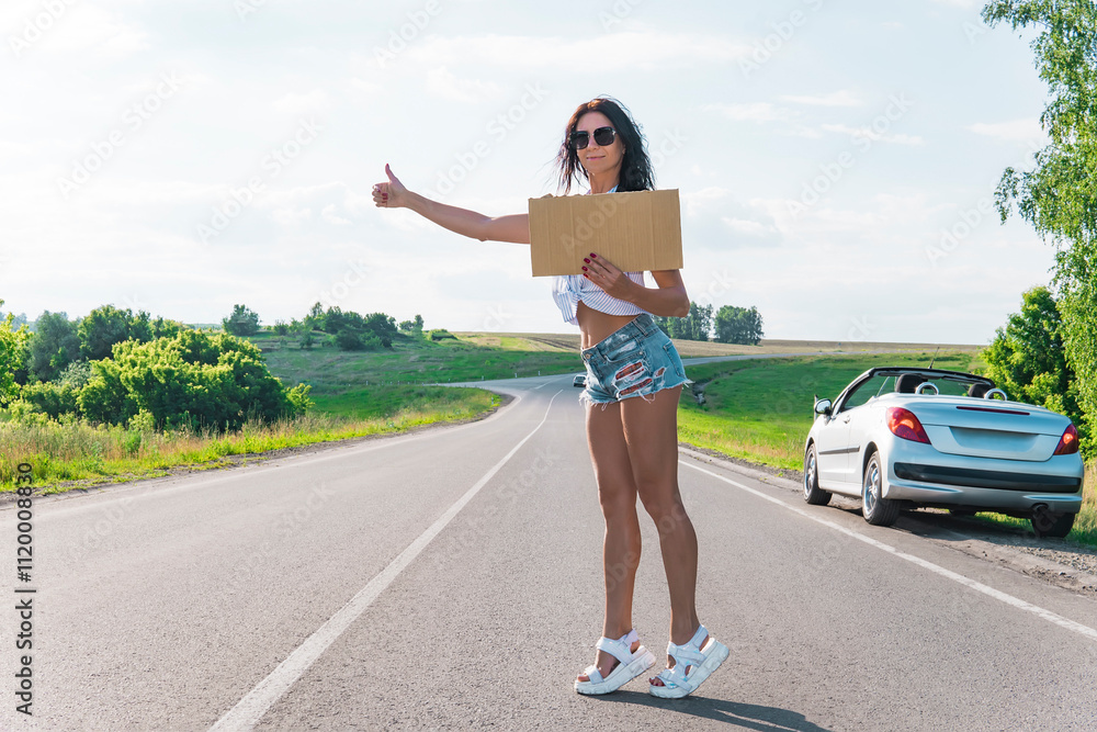 Summer tourism active lifestyle concept. Woman happy female tourist hitchhiking with blank sign cardboard. girl black long hair on the roadside holding a empty plate and catches car thumb up to go Summer tourism active lifestyle concept. Woman happy female tourist hitchhiking with blank sign cardboard. girl black long hair on the roadside holding a empty plate and catches car thumb up to go