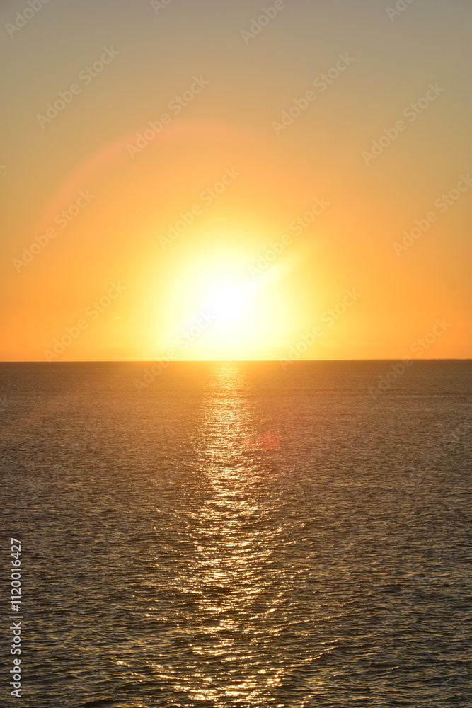 Stunning Pacific Ocean sunset with beams of colourful light shining up from the sea and islands in Fiji Stunning Pacific Ocean sunset with beams of colourful light shining up from the sea and islands in Fiji