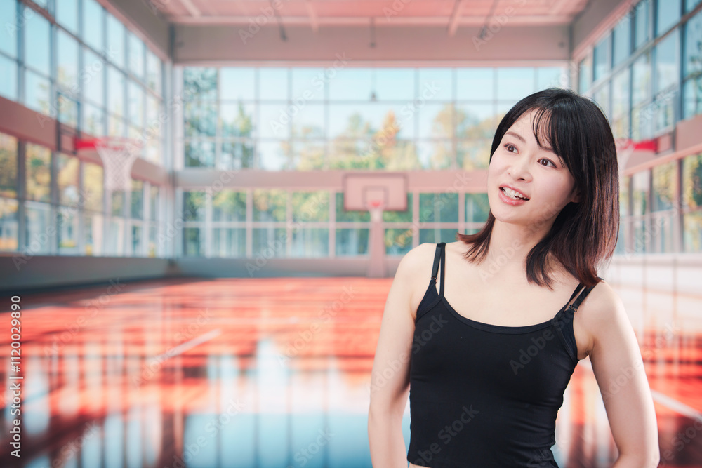 Fototapeta premium 体育館でスポーツを楽しむ若い女性