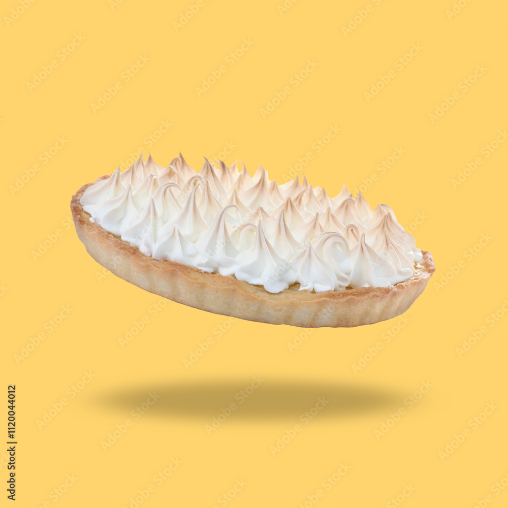 Delicious lemon meringue pie in air on golden background Delicious lemon meringue pie in air on golden background