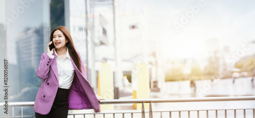 Beautiful Asian businesswoman in formal suit walking outdoors in city atmosphere