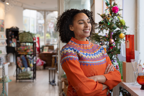 Small business owner looking out of store window planning business growth at Christmas photo