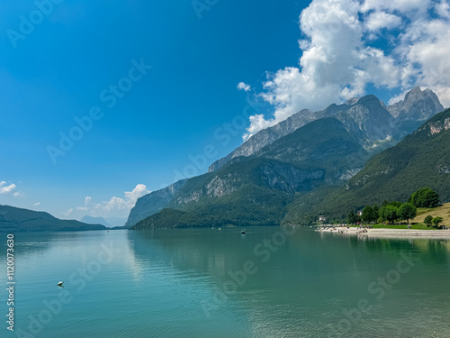 Idyllic mountain lake Lago di Molveno with scenic view of majestic mountains Brenta Dolomites, National Park Adamello Brenta, Trentino, North Italy. Serene lakeside atmosphere. Summer travel vacation photo