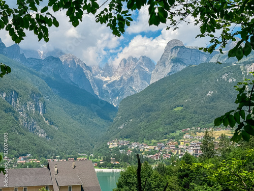 Alpine retreat village at idyllic mountain lake Lago di Molveno with scenic view of majestic mountains Brenta Dolomites, National Park Adamello Brenta, Trentino, Italy. Calm summer lakeside atmosphere photo