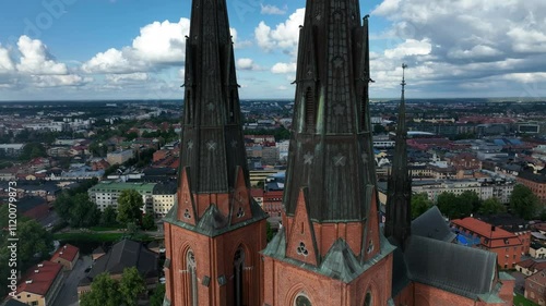 Drone footage of Uppsala Cathedral and cityscape with houses in Swedan