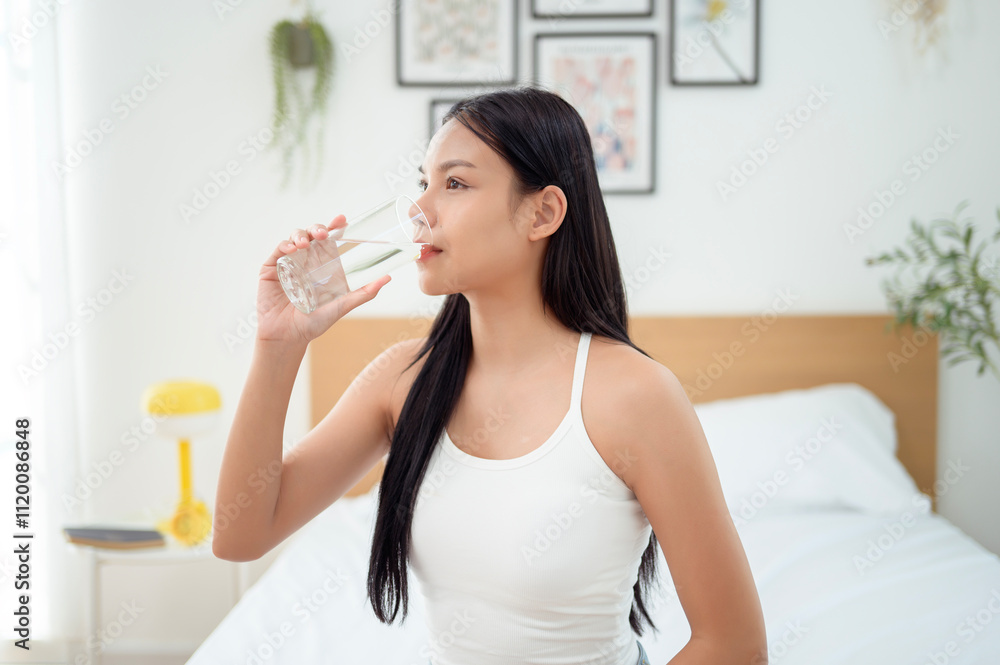 Young asian woman drinking water bedroom at home Young asian woman drinking water bedroom at home