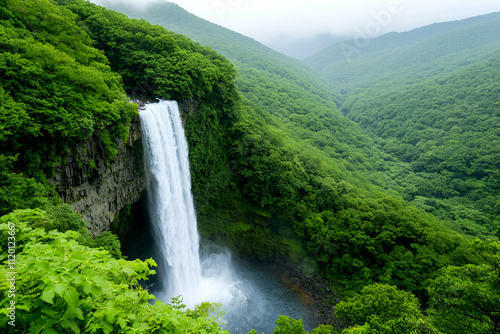 Lush green landscape with a stunning waterfall.