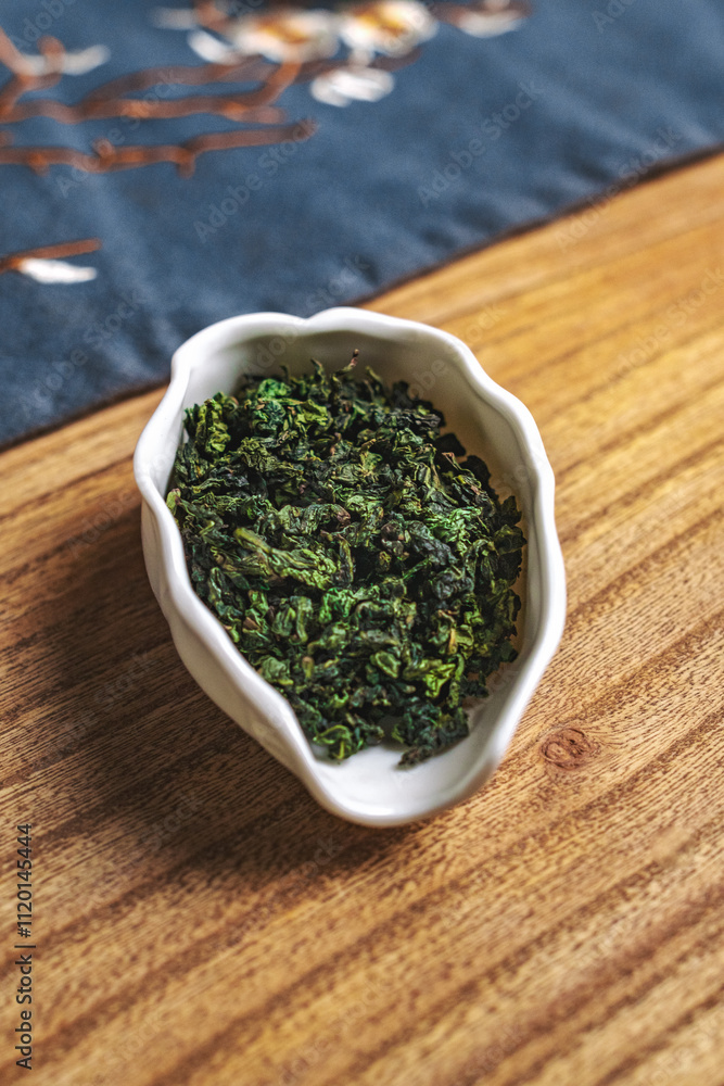 Aromatic Dried Green Herb Displayed in an Elegant Dish on a Beautiful Wooden Table Surface Aromatic Dried Green Herb Displayed in an Elegant Dish on a Beautiful Wooden Table Surface