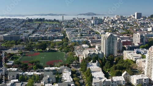 Tilting down over San Francisco towards a residential housing building and baseball field