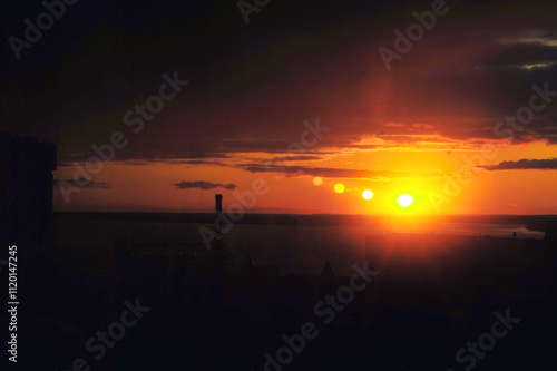 A stunning sunset casts its vibrant colors over tranquil waters