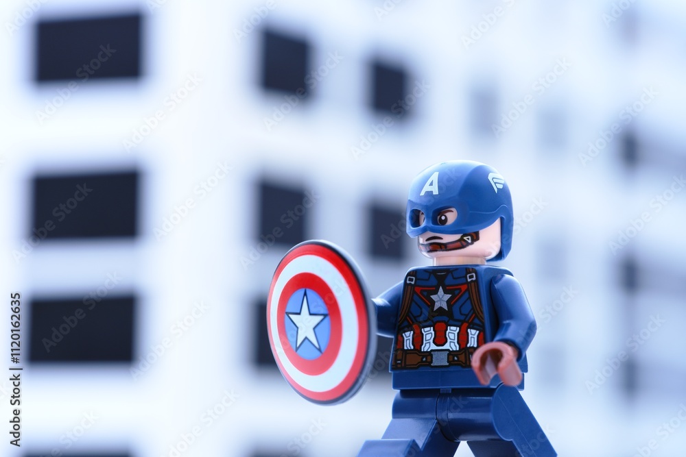 Naklejka premium Tambov, Russian Federation - November 05, 2024 Lego Captain America minifigure with a shield against an office building