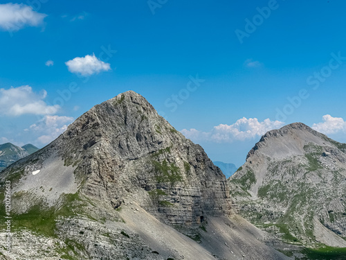 Scenic view of cloud covered rocky rugged mountain peak of Cima Dei Lasteri in majestic Brenta Dolomites, Trentino, Italy. Wanderlust in alpine wilderness. Hiking in pristine Italian Alps in summer photo