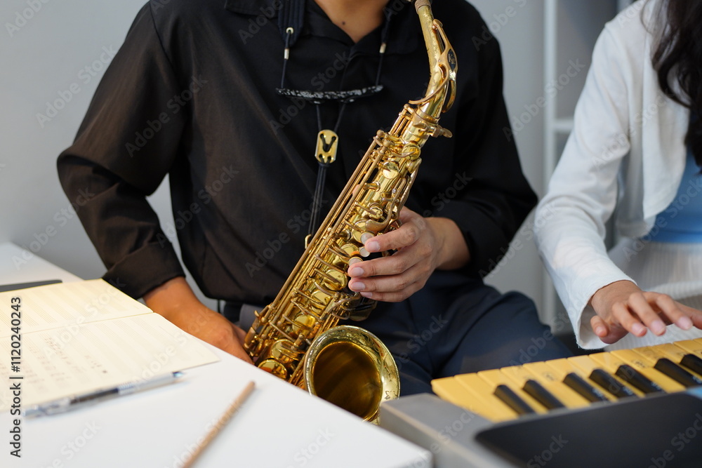 Naklejka premium Working Asians are learning international musical skills at home