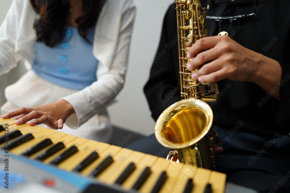 Naklejka premium Working Asians are learning international musical skills at home