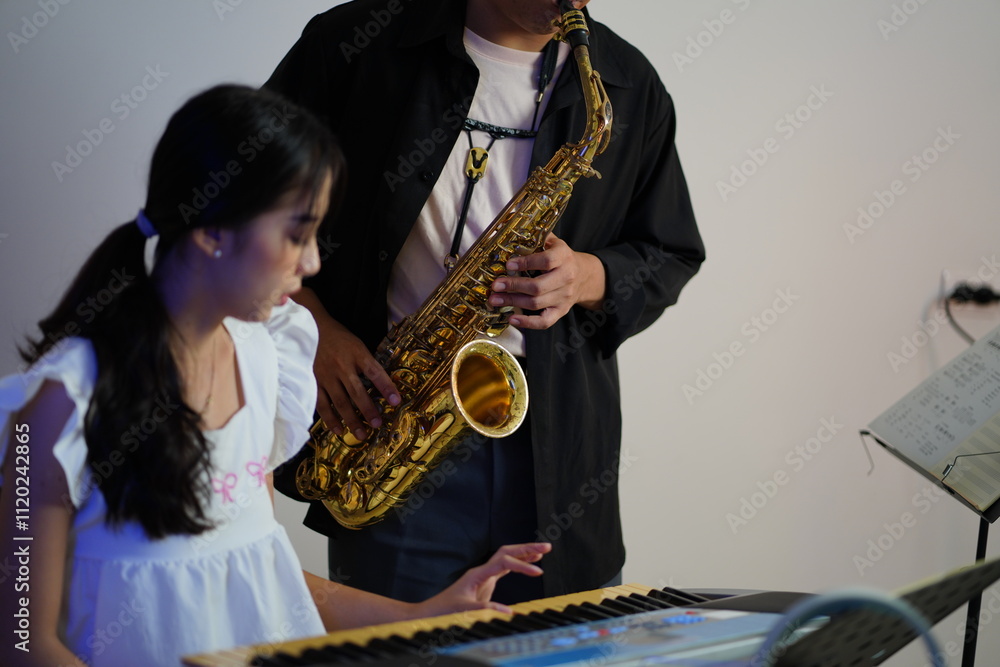 Fototapeta premium Working Asians are learning international musical skills at home