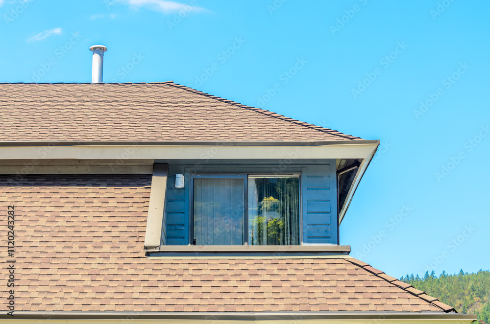 Top of grey stucco luxury house with shingle roof, red and yellow trees and nice windows in Summer in Vancouver, Canada, North America. Day time on June 2024. Top of grey stucco luxury house with shingle roof, red and yellow trees and nice windows in Summer in Vancouver, Canada, North America. Day time on June 2024.