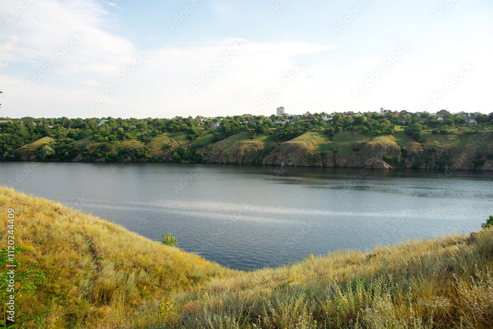 Scenic river view with lush green hills and a serene water body under a clear sky, perfect for nature and landscape photography enthusiasts Scenic river view with lush green hills and a serene water body under a clear sky, perfect for nature and landscape photography enthusiasts