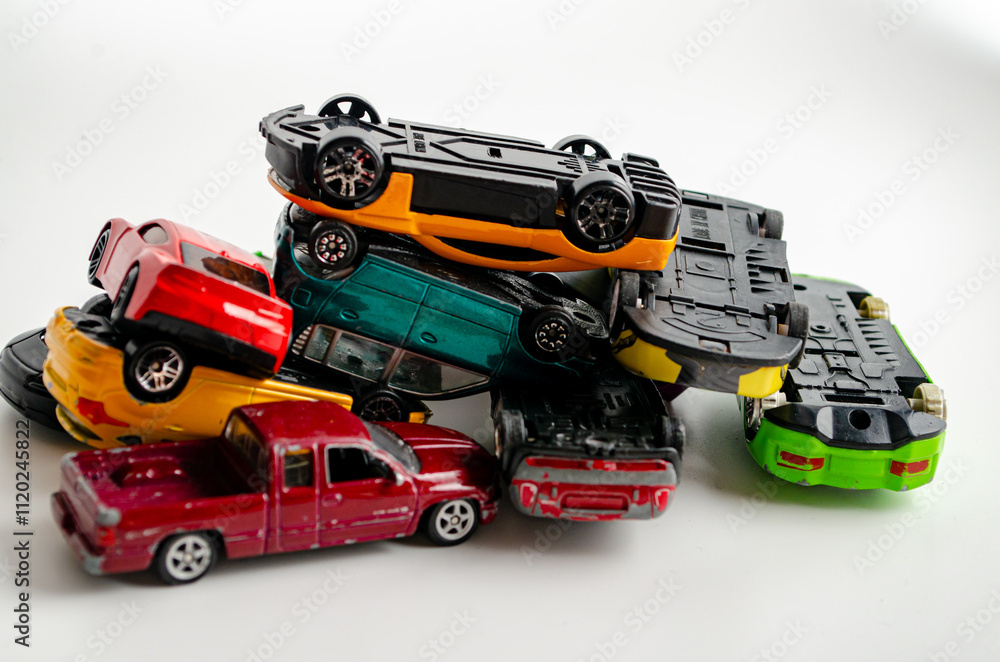 a group of small toy cars piled up in a heap a group of small toy cars piled up in a heap