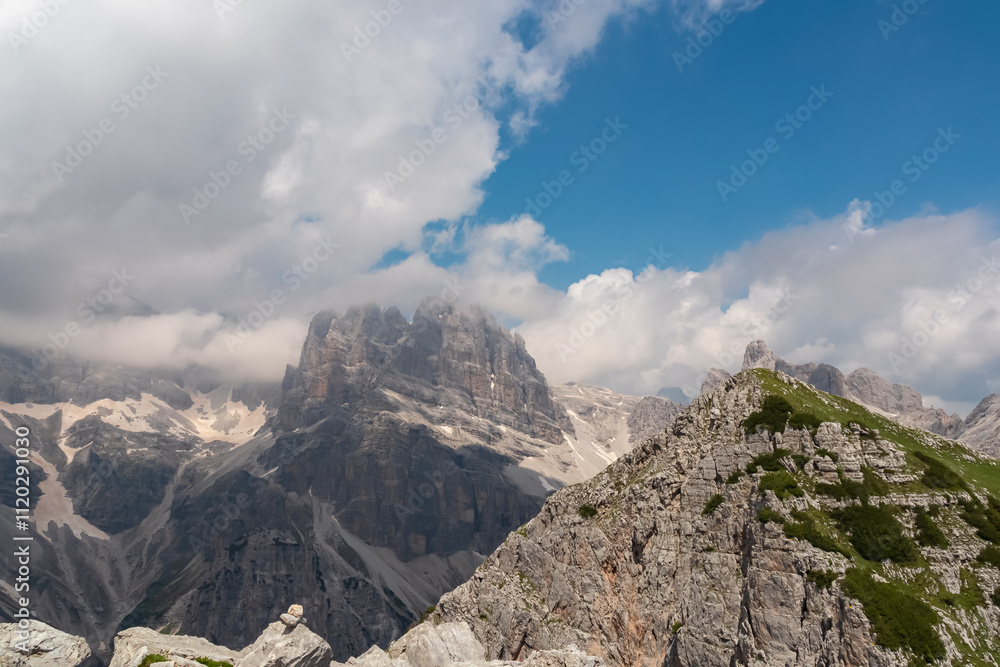 On top of Croz dell'Altissimo with panoramic view of majestic cloud covered rugged mountain peaks of Brenta Dolomites, Trentino, Italy. Wanderlust in alpine wilderness Italian Alps. Summer hiking tour On top of Croz dell'Altissimo with panoramic view of majestic cloud covered rugged mountain peaks of Brenta Dolomites, Trentino, Italy. Wanderlust in alpine wilderness Italian Alps. Summer hiking tour