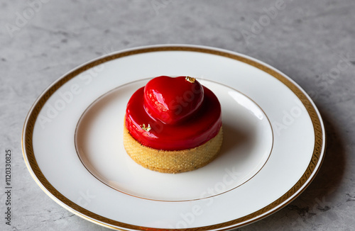 Dessert in the form of a heart on a white plate.