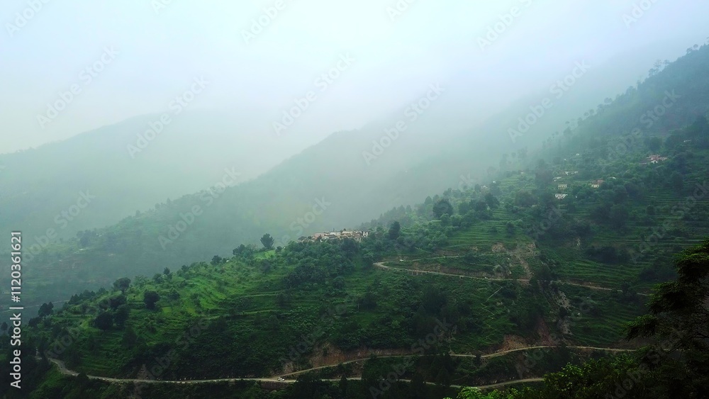 Fototapeta premium Breathtaking Misty Mountain Landscape Featuring Winding Roads and Scenic Views Everywhere. Stock Clip