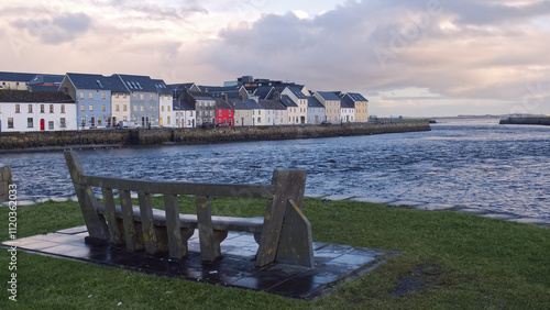 Obraz na płótnie Beautiful cityscape sunrise scenery with old wooden boat in Corrib river at Claddagh in Galway city, Ireland, architecture background w salonie