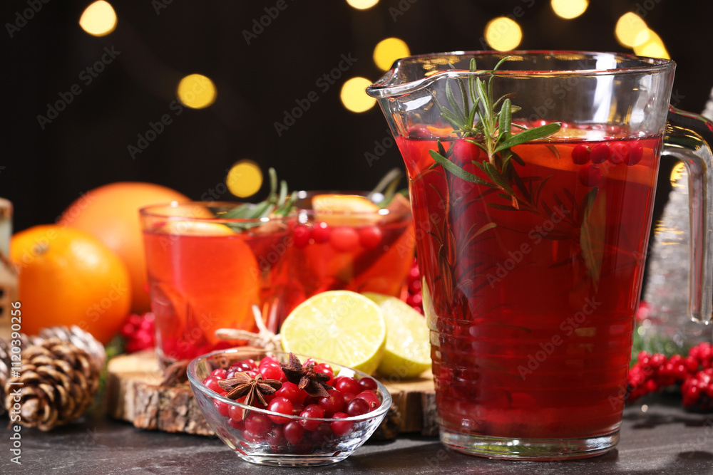 Tasty punch drink and ingredients on dark table against blurred lights, closeup Tasty punch drink and ingredients on dark table against blurred lights, closeup