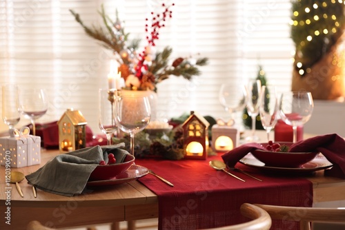 Christmas table setting with stylish dishware and festive decor indoors