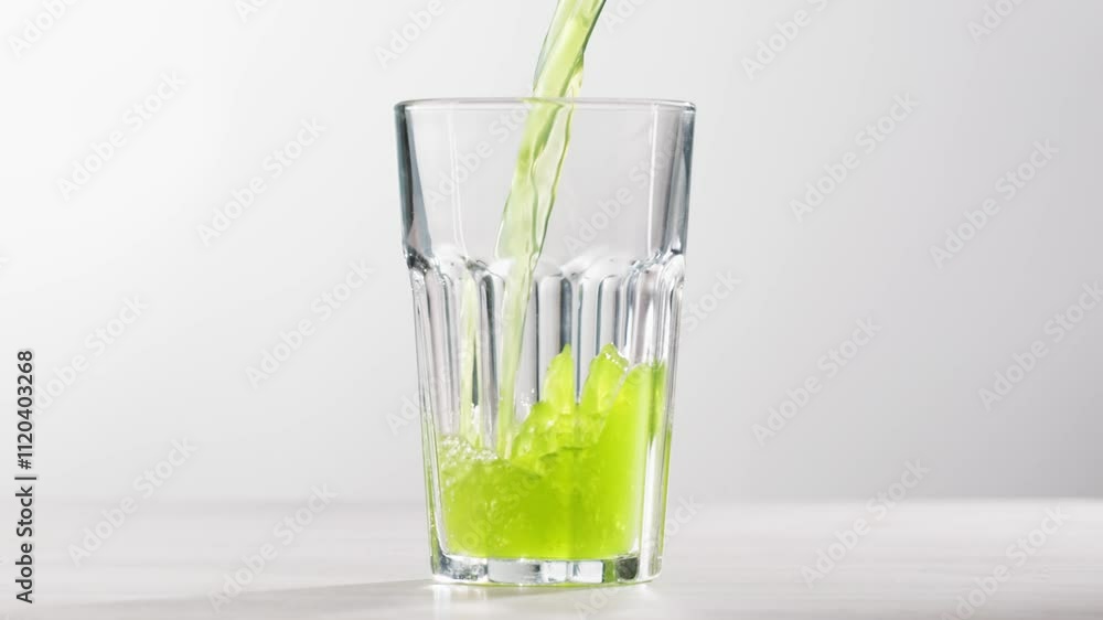 Fresh Green detox juice with cucumber, celery, apple and ginger and mint in glasses and jars. Pouring Vegan juice detox concept. Fresh Green detox juice with cucumber, celery, apple and ginger and mint in glasses and jars. Pouring Vegan juice detox concept.