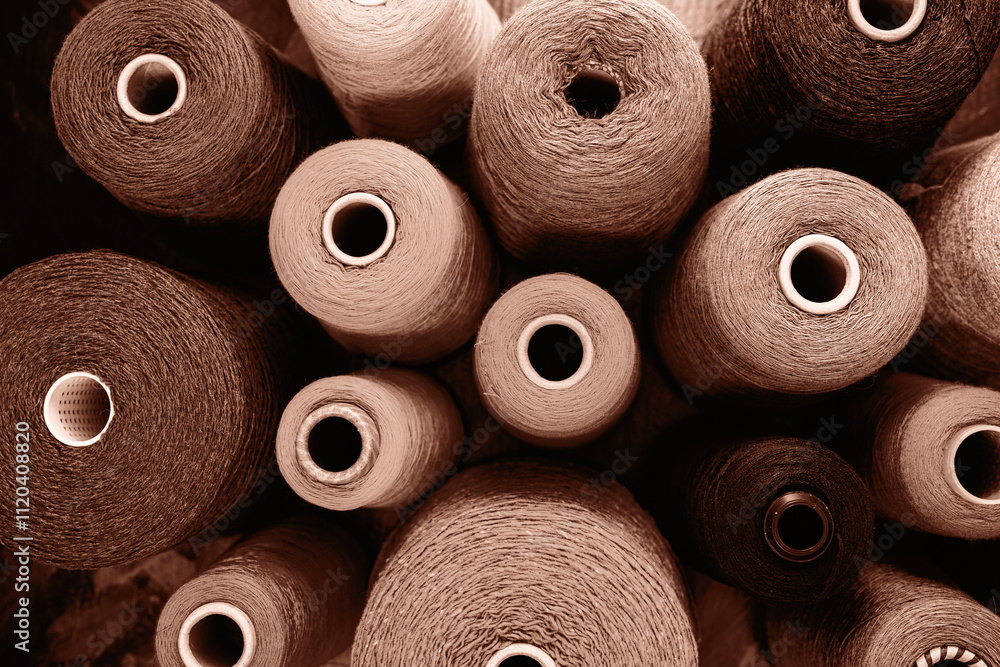 Close-up image showcasing multiple yarn spools in an array of earthy tones. Demonstrating color of 2025 year. Close-up image showcasing multiple yarn spools in an array of earthy tones. Demonstrating color of 2025 year.
