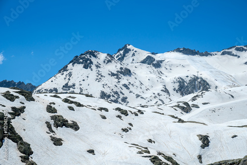 Snow-covered Peaks in Vermiglio Showcase the Beauty of the Italian Alps in Clear Blue Skies