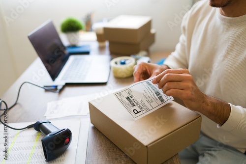 Canvastavla Closeup of ecommerce business owner using laptop and barcode scanner to prepare