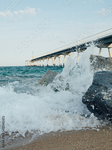 Agua salpicando las rocas del Pont del Petroli, Badalona, cataluña photo