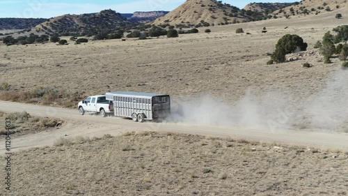 Aerial of truck pulling horse trailer in Central Utah desert on dirt road