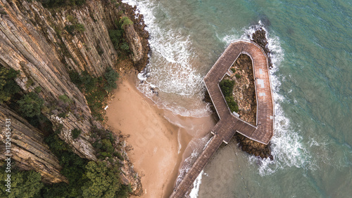 Observation deck overlooking the sea and lava rocks captured by a drone. A stunning spot for nature lovers.