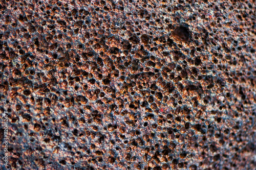 Closeup detail of rough brown volcanic rock on a beach in Maui
