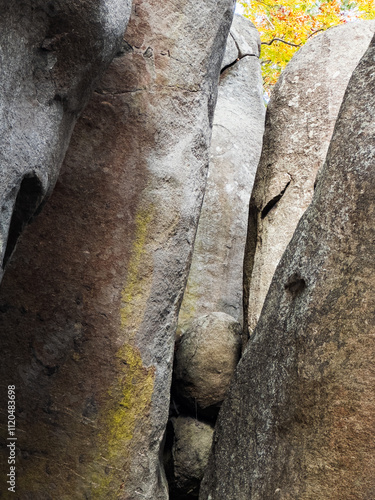 Tall corridors of white granite rock and round chock stones near Asheboro, North Carolina, with yellow autumn leaves in the background
