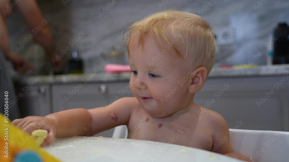 A curious toddler explores vibrant toys while seated at a kitchen table, enjoying a playful afternoon with family in a cozy space A curious toddler explores vibrant toys while seated at a kitchen table, enjoying a playful afternoon with family in a cozy space