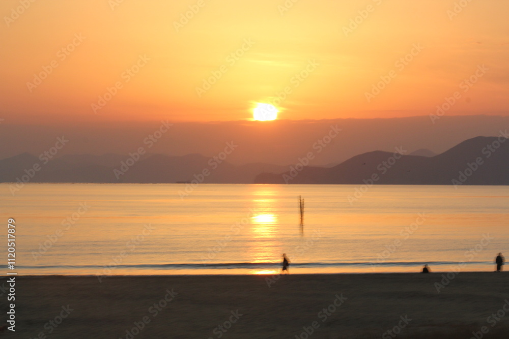 Image of people enjoying a beautiful sunset at Dadaepo Beach in Busan and a landscape image of sunset at sea
Image of people enjoying a beautiful sunset at Dadaepo Beach in Busan and a landscape image of sunset at sea